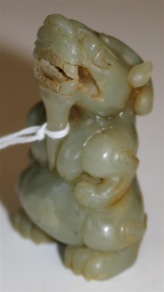 A Chinese celadon jade figure of a mythical horned beast, Ming dynasty or later, 6.8cm(-)